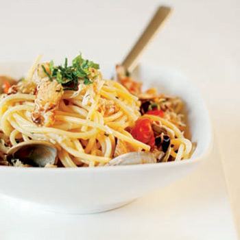 Image of Spaghetti with Fresh Crab, Clams, Mint and Spicy Cherry Tomatoes